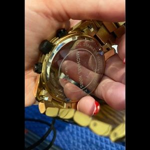 Michael Kors unisex black and gold watch.